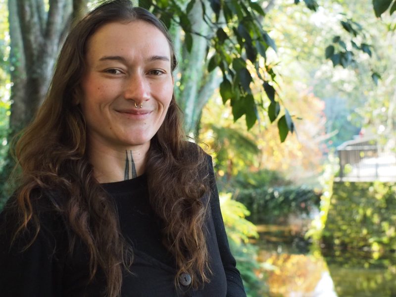 Tui Goomes, founder of Nectar & Honey Atelier, smiling in a garden in the Bay of Plenty