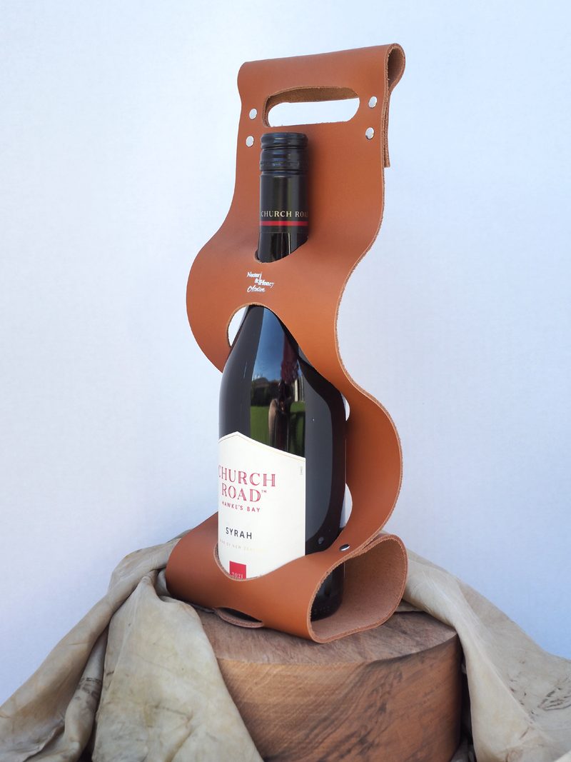 Tan leather wine carrier holding a bottle of Church Road Syrah