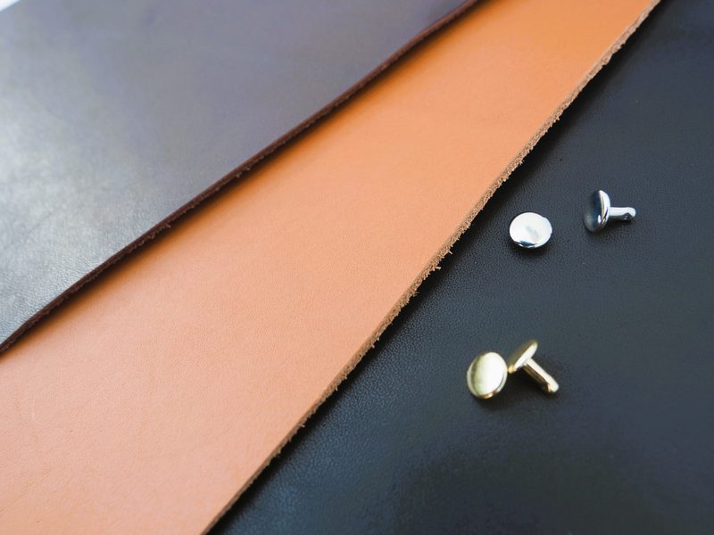 Tan, chocolate and black premium top grain leather swatches with silver and gold rivets